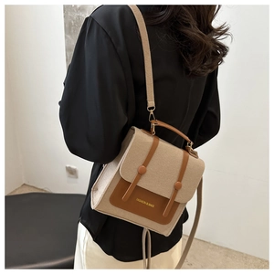 Retro beige felt crossbody bag with brown leather trim shown on model for size