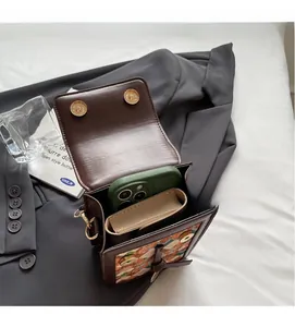 Interior view of vintage crossbody bag showing capacity for phone and wallet with dual snaps