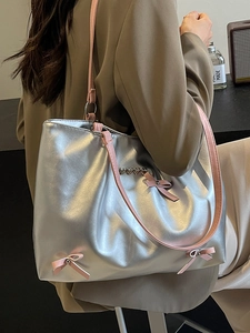 Metallic silver tote bag with pink bows and heart details for women's casual style