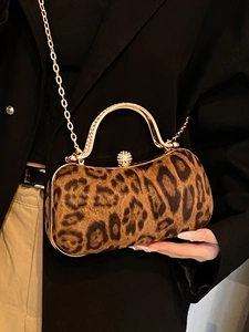 Leopard print hard shell clutch bag with gold diamond handle and chain strap for evening wear