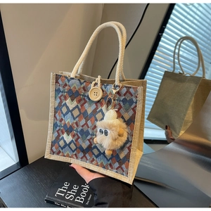 Detail of woven tote bag with geometric diamond patterns and round wooden button closure