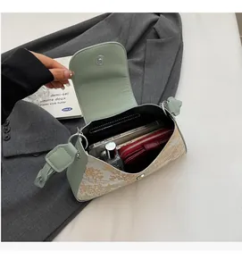 Internal view of green baguette bag showing space for phone, wallet and perfume