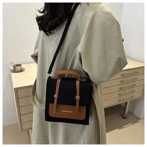 Close-up of a retro patchwork crossbody bag with canvas and leather details on a model
