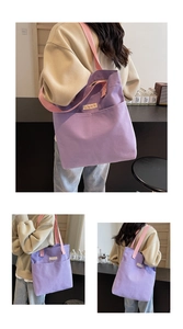 Detail view of large purple canvas tote bag with pink straps and external pocket