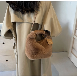 Detail of caramel plush handbag with ruched leather handle and golden chain strap