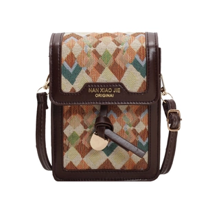 Retro woven crossbody bag with geometric pattern and dark brown leather trim on white background