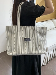 Large capacity black and white vertical striped canvas tote bag with fashion label