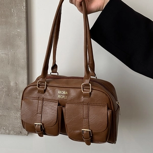 Brown leather Boston bag with dual buckled pockets and golden hardware detail