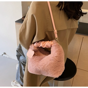 Detail of pink faux fur plush handbag with scrunchie handle and leather strap