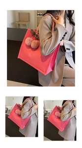Detail of rose pink linen tote bag with decorative plush cherry charm and soft fabric strap