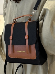 Minimalist felt and leather patchwork crossbody bag worn over a green shirt