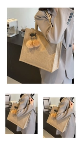 Detail of a beige linen tote bag featuring a cute plush cherry pendant for school