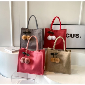 Linen tote bags in dark gray, red, pink, and khaki with cherry pendant detail