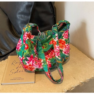 Macro shot of green floral fabric bag with traditional peony and phoenix patterns