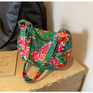 Detail of vibrant green floral tote with traditional phoenix and peony embroidery patterns