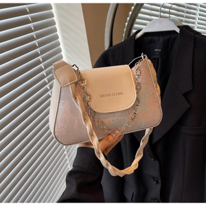 Detail of off-white baguette bag with floral jacquard patterns and metal buckle