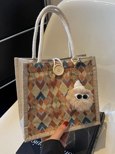 Waterproof linen tote bag with geometric pattern, rope handles and plush monster charm