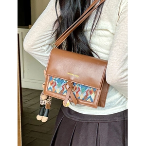 Vintage brown leather crossbody bag with geometric woven pattern and bear charm