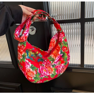 Detail of red floral hobo bag with traditional peony and phoenix embroidery patterns