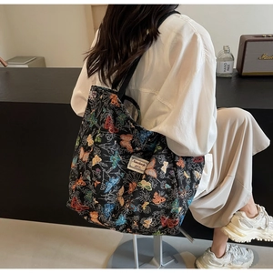Close-up of colorful butterfly jacquard tote bag with white tag and black strap