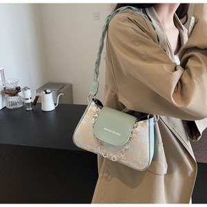Detail of mint green and beige floral baguette bag with acrylic flower chain decoration