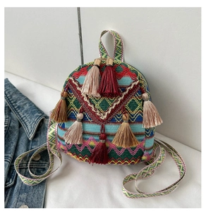 Detail of colorful woven bohemian backpack featuring geometric patterns and fringe accents