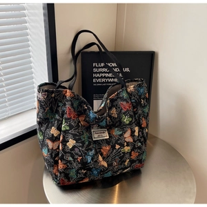 Close-up of a large capacity canvas tote bag with colorful butterfly jacquard patterns