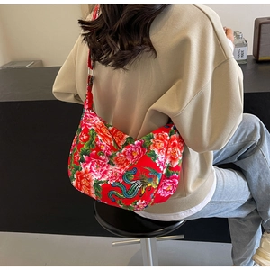 Detail of red floral hobo bag featuring traditional peony and phoenix embroidery patterns