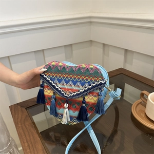 Ethnic style heart-shaped woven crossbody bag with colorful patterns and tassels