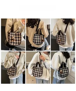 Detail view of retro plaid handbag with bear charm shown in multiple wearing styles