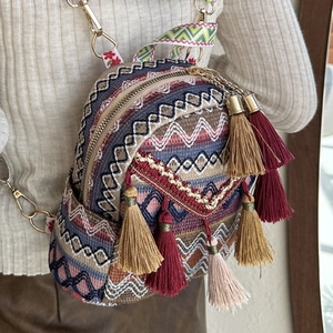 Ethnic bohemian mini backpack with colorful woven geometric patterns and vibrant tassels