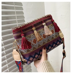 Detailed macro view of bohemian woven crossbody bag with colorful tassels and fringe