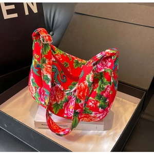 Detailed view of large capacity floral moon bag with red peony patterns and adjustable strap