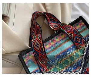 Detail of comfortable woven handles on a multi-color bohemian style large tote bag