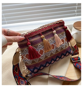 Close-up of bohemian crossbody bag with colorful woven patterns and long fringe tassels