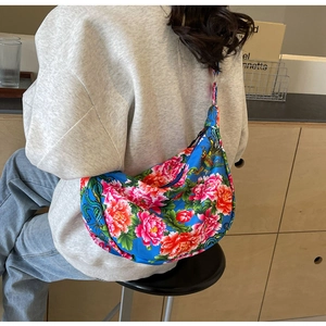 Detail view of large ethnic floral shoulder bag with red peonies and phoenix embroidery