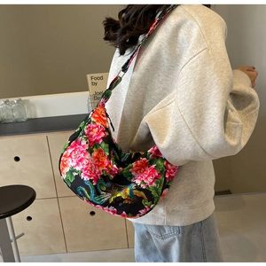Detailed shot of large hobo bag featuring ethnic floral patterns and phoenix embroidery