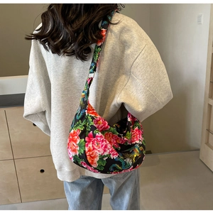 Detailed back view of a large tote bag with traditional floral and peacock patterns