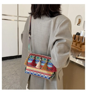 Close-up of bohemian woven crossbody bag with colorful tassels and geometric patterns