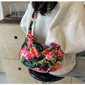 Detail of floral tote bag with red peony and phoenix patterns and wide shoulder strap