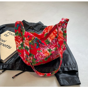 Detail of red floral hobo bag featuring traditional Chinese peony and phoenix patterns