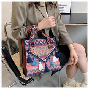 Ethnic woven tote with geometric patterns, bohemian tassels and colorful wide strap
