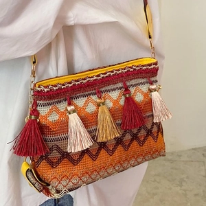 Ethnic bohemian woven crossbody bag with colorful patterns and tassel charms