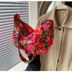 Detail of red floral canvas bag with traditional Chinese peony and dragon patterns