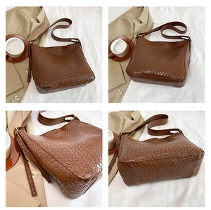 Close-up of dark brown hand-woven leather texture on a vintage style shoulder bag