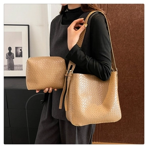 Detail of camel woven texture tote bag set with matching pouch and wide shoulder strap