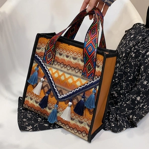 Ethnic embroidered tote bag with geometric patterns and colorful tassels detail