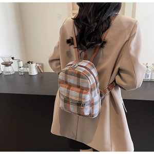 Detail of the mini plaid backpack with blue and orange fabric and brown leather straps