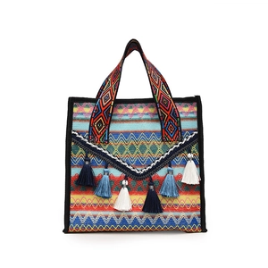 Ethnic woven tote bag with colorful geometric patterns and decorative tassels