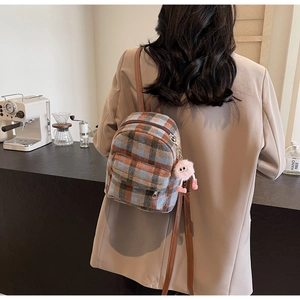 Mini brown plaid backpack for women with plush monster charm and leather straps detail